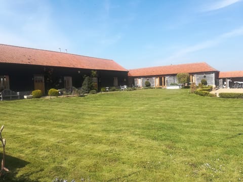 Large shared front lawn.  At the back each barn has its own patio and garden .