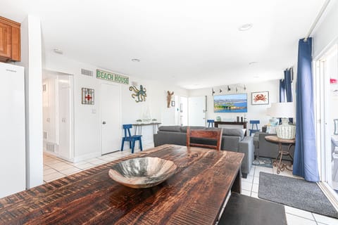 Beyond the living area is the dining area with table and seating for six
