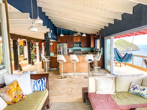 Living Room looking into Kitchen.  Ocean one side, open courtyard on the other