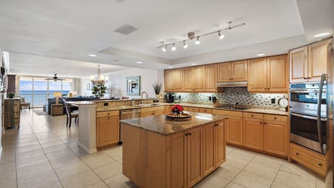 Large custom kitchen with an island and beach views