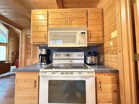 Full size kitchen with appliances, pots and pans, dishes, utensils, and basic cooking essentials.