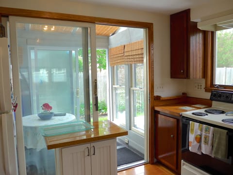 View Kitchen thru' greenhouse to access outside wooden deck, gas grill & garden