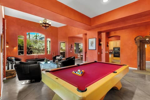 Entertainment hub with pool table attached to the living room