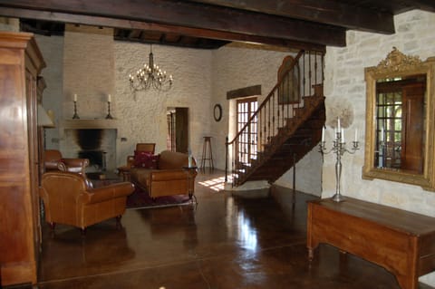 Living room with leather club furniture and 2 stone fireplaces