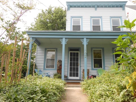 A lush garden surrounds THE MONROE HOUSE.