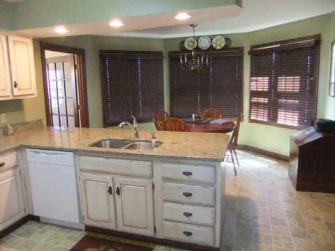 Kitchen with bay window and bar stools at counter