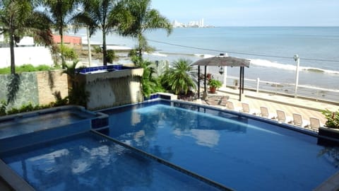 View from the living room of pool area, beach in front of the condo and Salinas