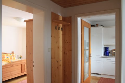 View from the hallway to wardrobe, bedroom and kitchen