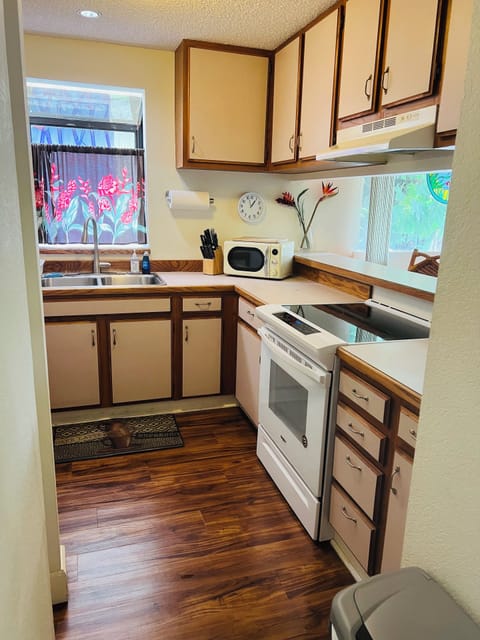 Fully stocked kitchen with pots, pans, silverware and dishes.