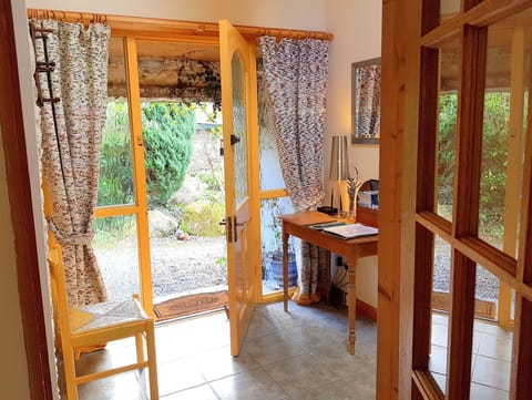 Front Hall seen from the kitchen with the front door to the courtyard  garden 