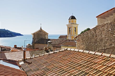 Window view of Villefranche old town, bay, and Cap Ferat