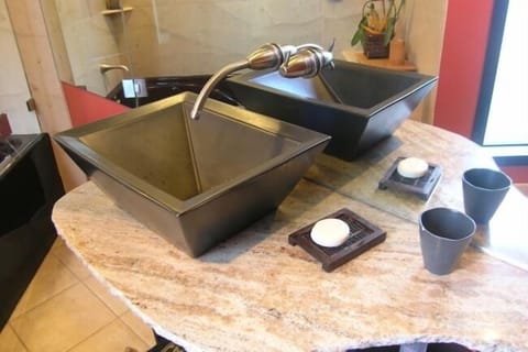 Spacious Asian motif bathroom on mid level with tile floor and jacuzzi bathtub