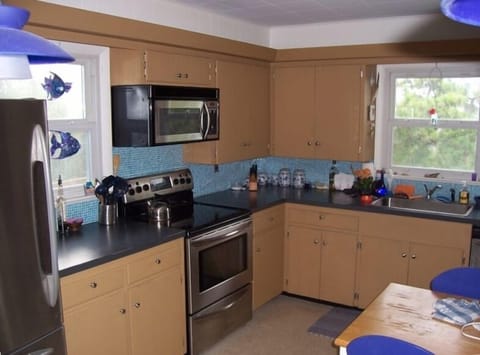 Kitchen with bar opens to dining room