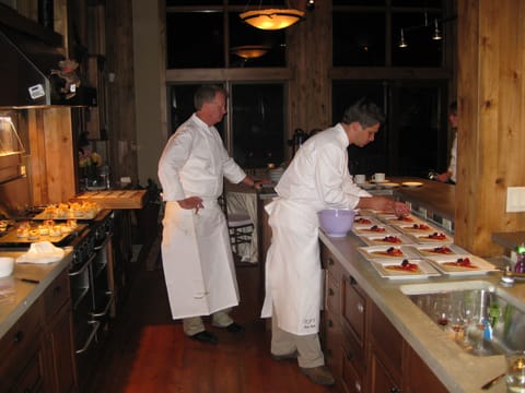 Plating dinner in open kitchen for guests