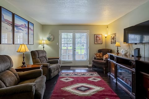 Living area looks out on green way.