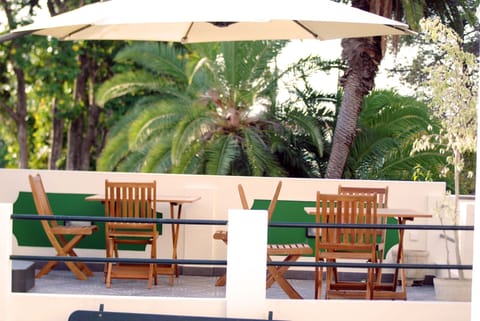 Terrace in front of Magnolia Garden with view to palm garden over the street.