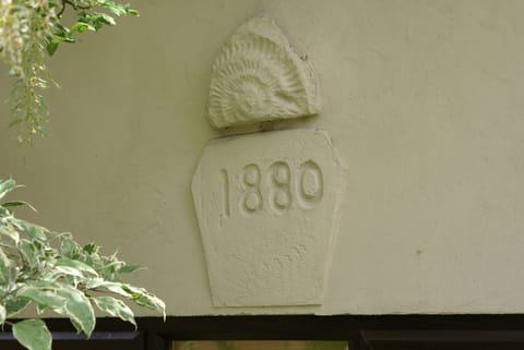 Wall plaque from the original outbuilding