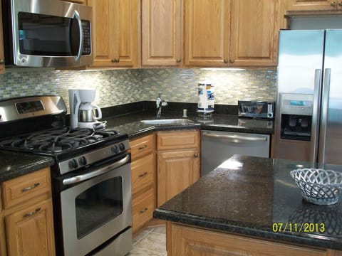 Kitchen with stainless appliances and island.