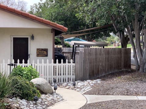 Bungalow fenced Shaded Patio on Right.