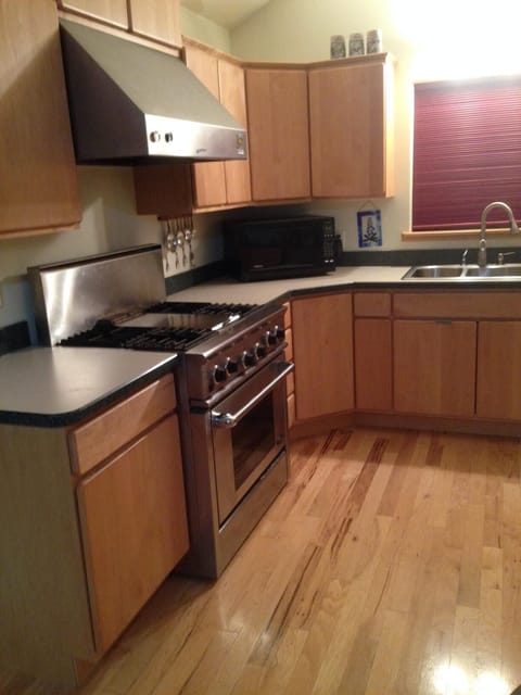 Full kitchen with full sink stovetop and range.