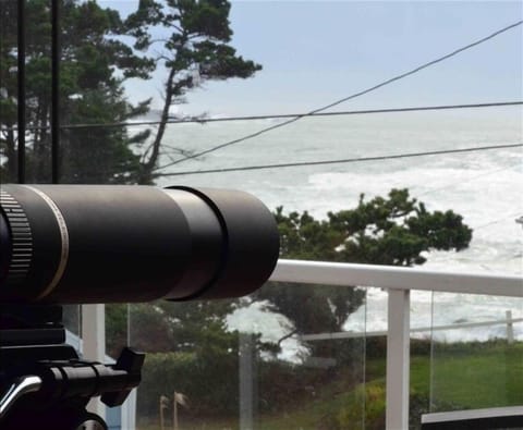 View off front deck of house; large deck with outdoor table and chairs