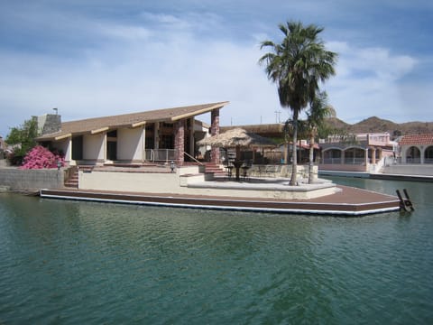 House is on the main canal and has extra large patio and huge wrap around dock