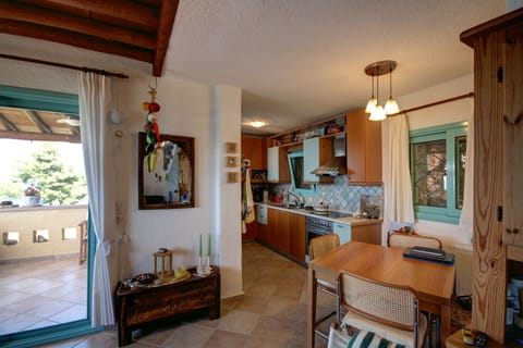 The kitchen area (fully equipped) with the dining area.