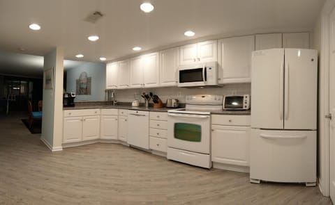 Open  Kitchen with Quartz Counter Tops. French door refrigerator.