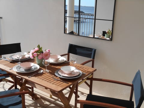 Lunch on the terrace overlooking the port and boats sailing in and out