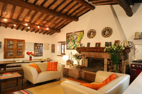 Kitchen/sitting room with dining table in the background.