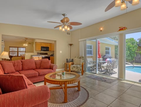 living room with double sliders to pool