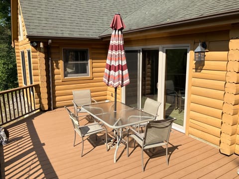 Dining and relaxing on the deck, doors open out from the kitchen