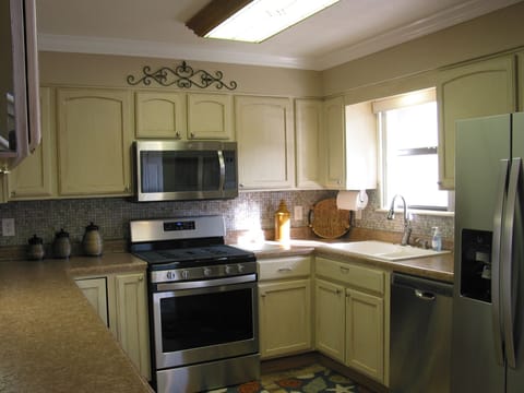 New stainless appliances. Cream glazed cabinets and tile back splash. 