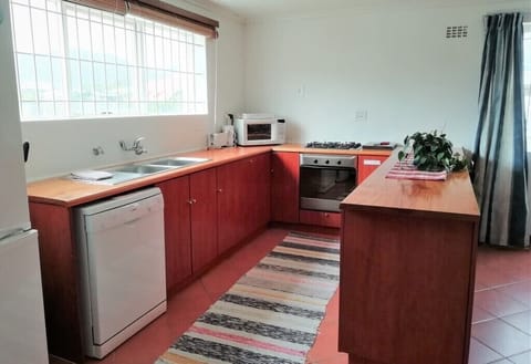 Fully equipped kitchen including a dishwasher and washing machine. 