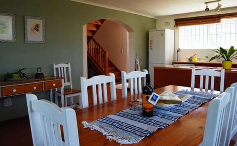 Open plan dining room between kitchen and outdoor BBQ area.