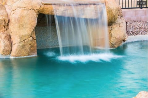 Beautiful waterfall with grotto overlooking McDowell Mountains