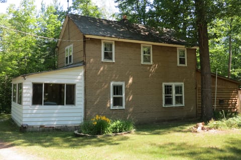 The large oak trees keep the cabin shaded and cool.