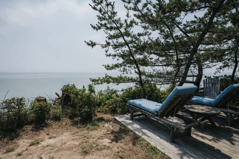 Sun chairs on the Beach Cottage deck overlooking the bay
