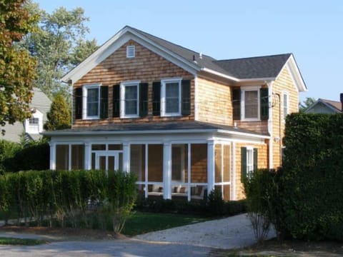 The front of the house with a screened-in porch
 
