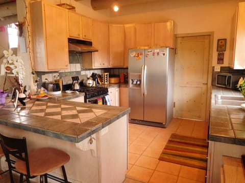 View of gas range/oven, spice rack, toaster, microwave (coffee pot out of view).