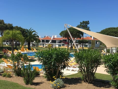 Heated circular pool with apartment in the background