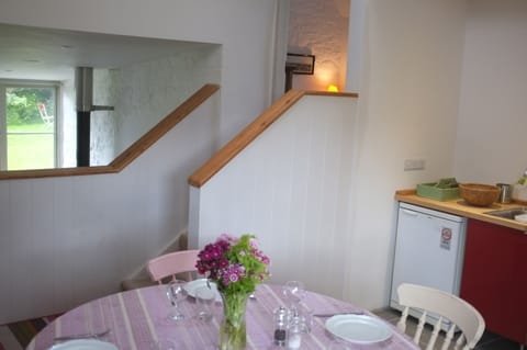 Kitchen, and steps up to ensuite bedroom. Sitting down to the left