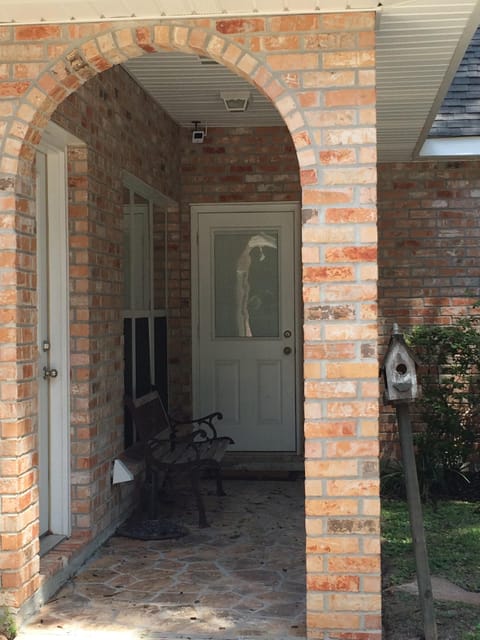 Side porch with door that enters the utility room