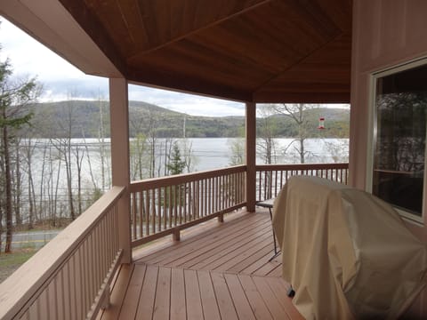view from side of wrap around porch looking out front towards lake