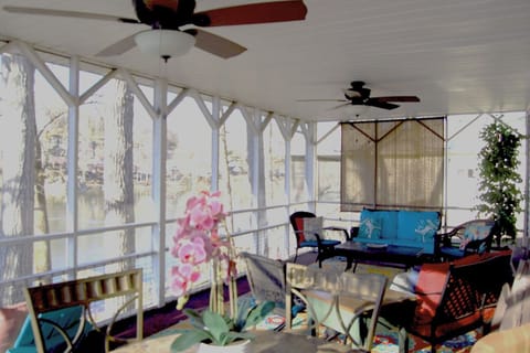 Large screened porch with ceiling fans.