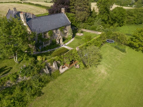 The main garden showing the fire-pit and outside dining area under the vines.