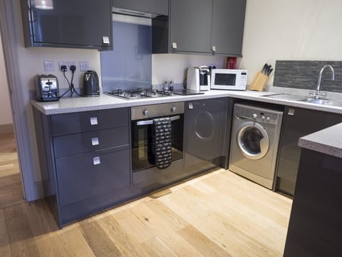 The kitchen complete with everything needed to prepare, cook and serve a meal.