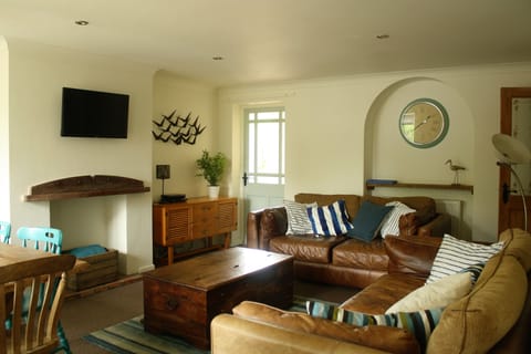 Comfortable leather sofas provide seating for 6...