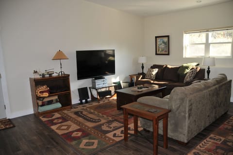 Living room area with sitting area (including sofa bed) and flat screen