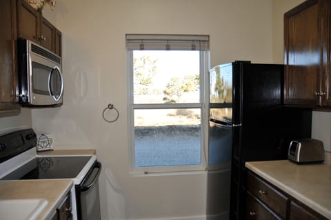 Kitchen with stove, fridge and microwave